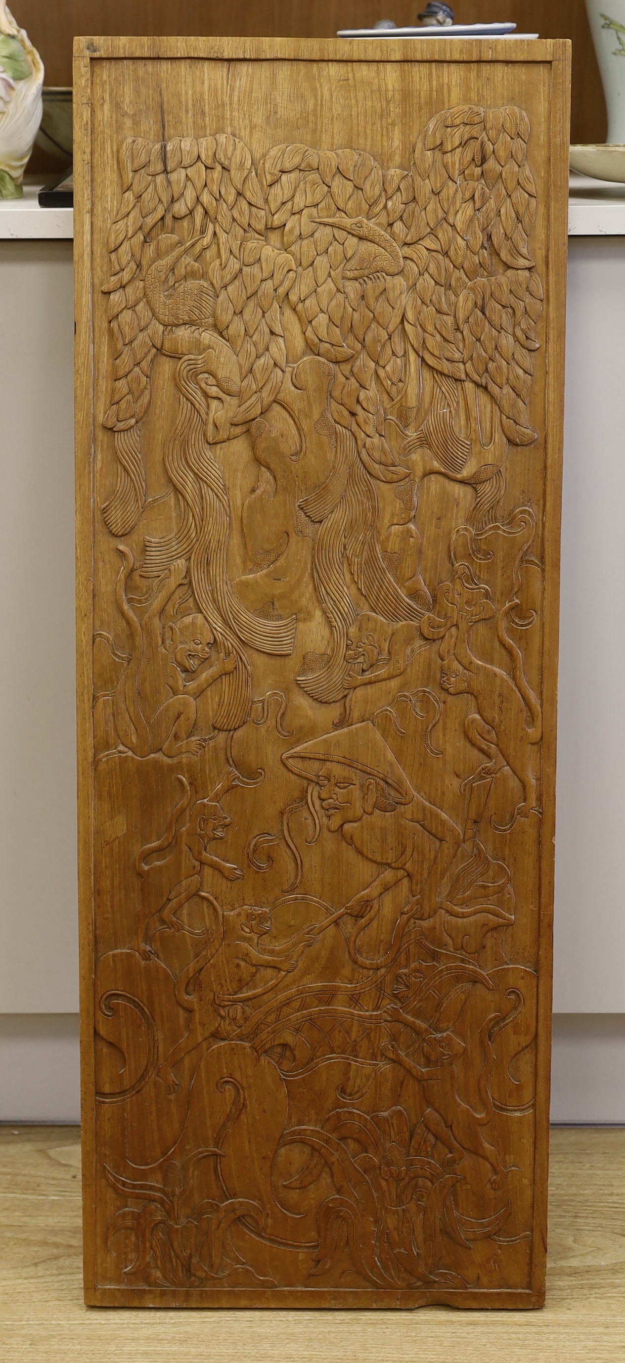 A Balinese carved figural and animal wood panel, 39.5cm wide x 41cm high